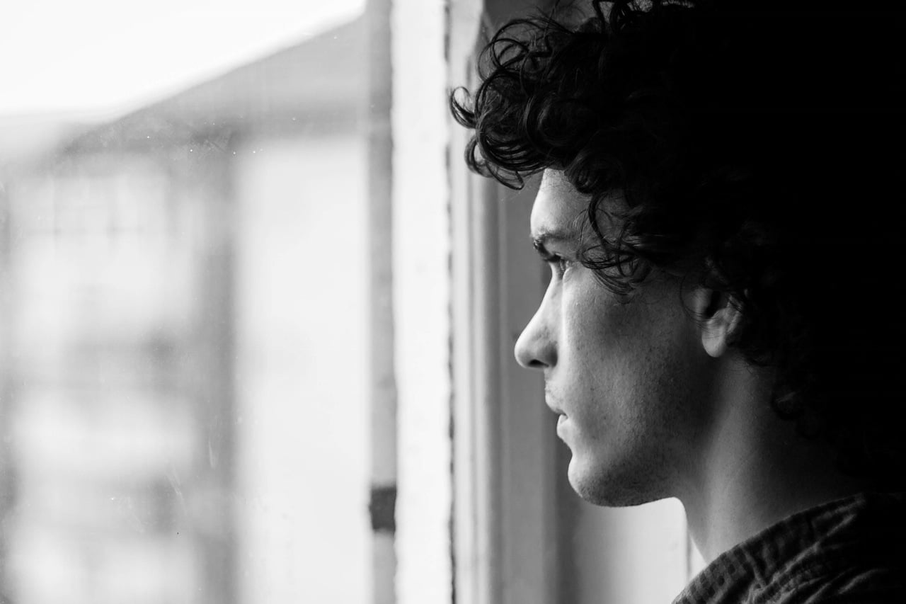 man-looking-out-window