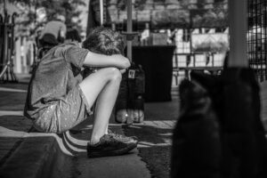 boy sitting on a curb