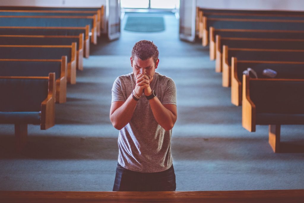 man on his knees praying