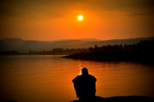 man-looking-into-sunset