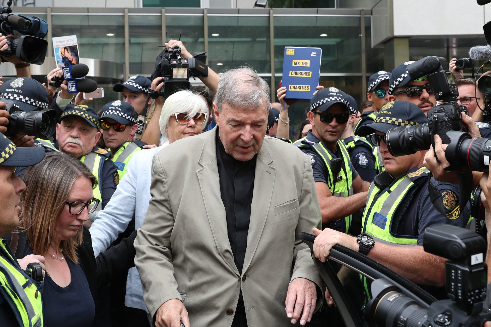 george pell leaving court with police escort