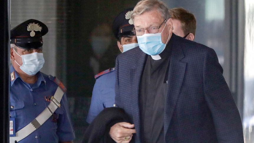 george pell returns to rome in face mask