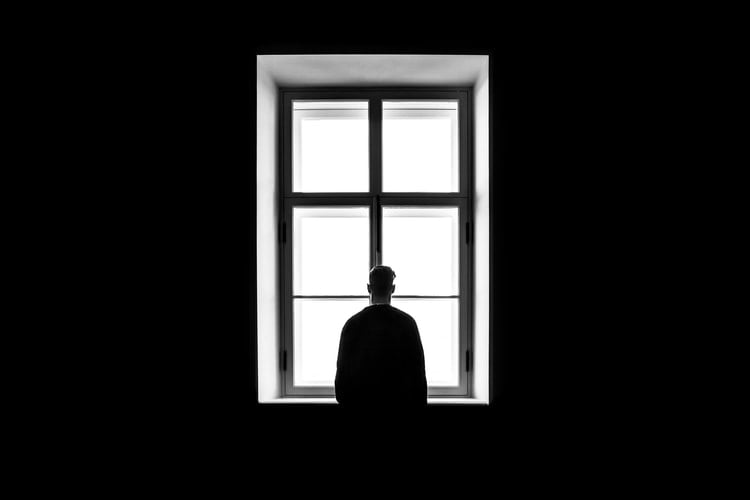 lonely man looking out window