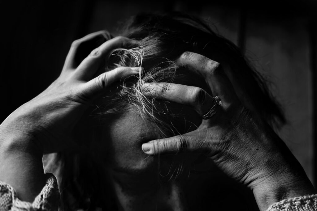 woman holding her head in her hands