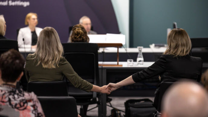 women holding hands at commission 