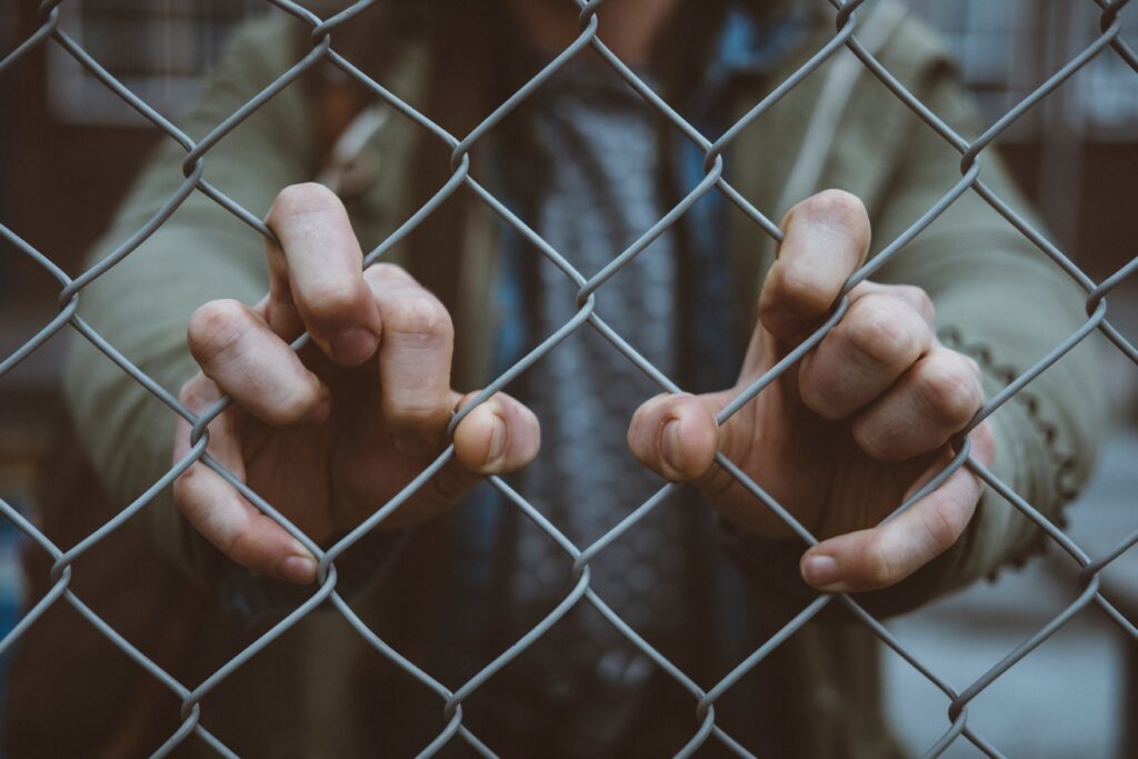 hands through fence