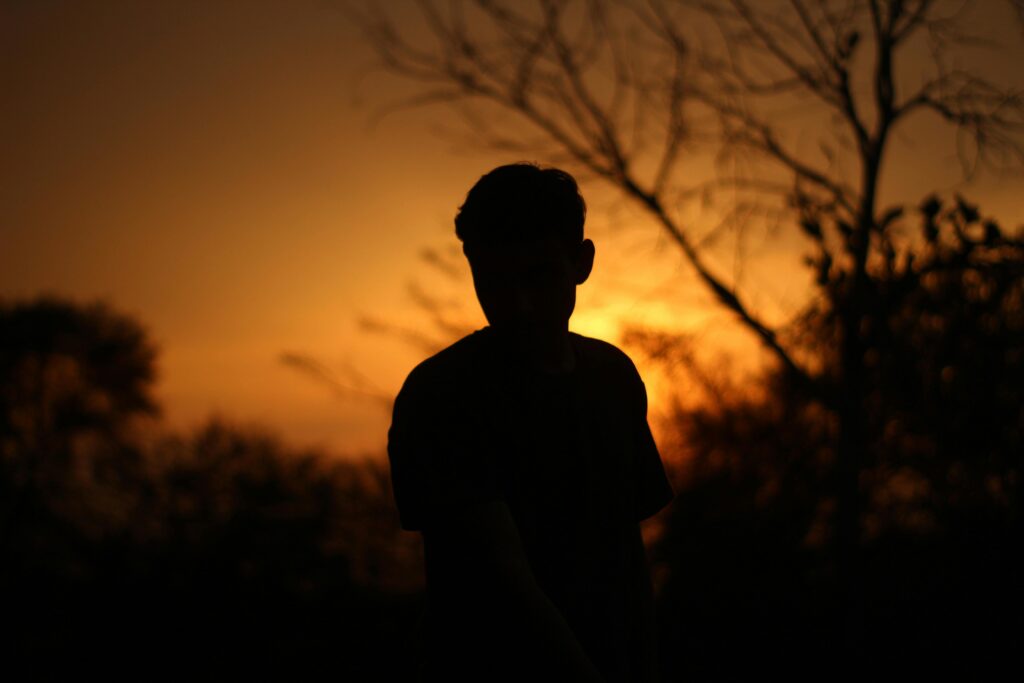 silhouette of a young boy in sunset