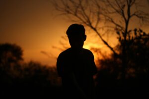 silhouette of a young boy in sunset