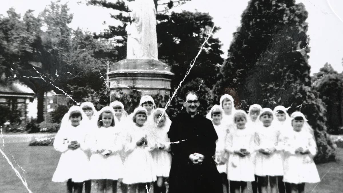 Gerald Ridsdale with a group of girls making their communion