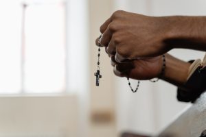 man holding prayer beads