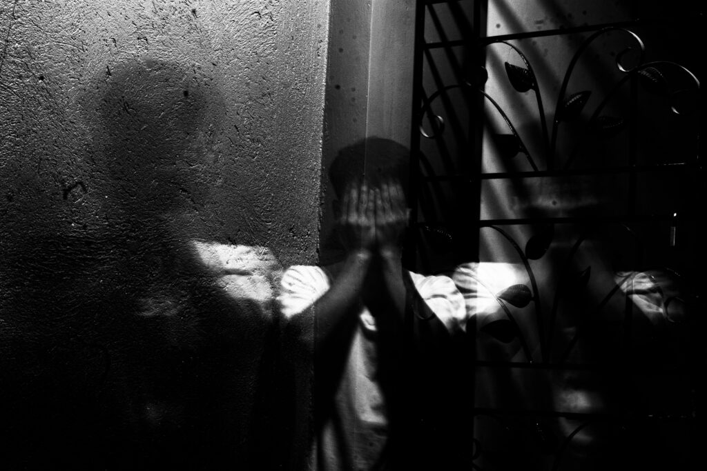 teen hiding his face