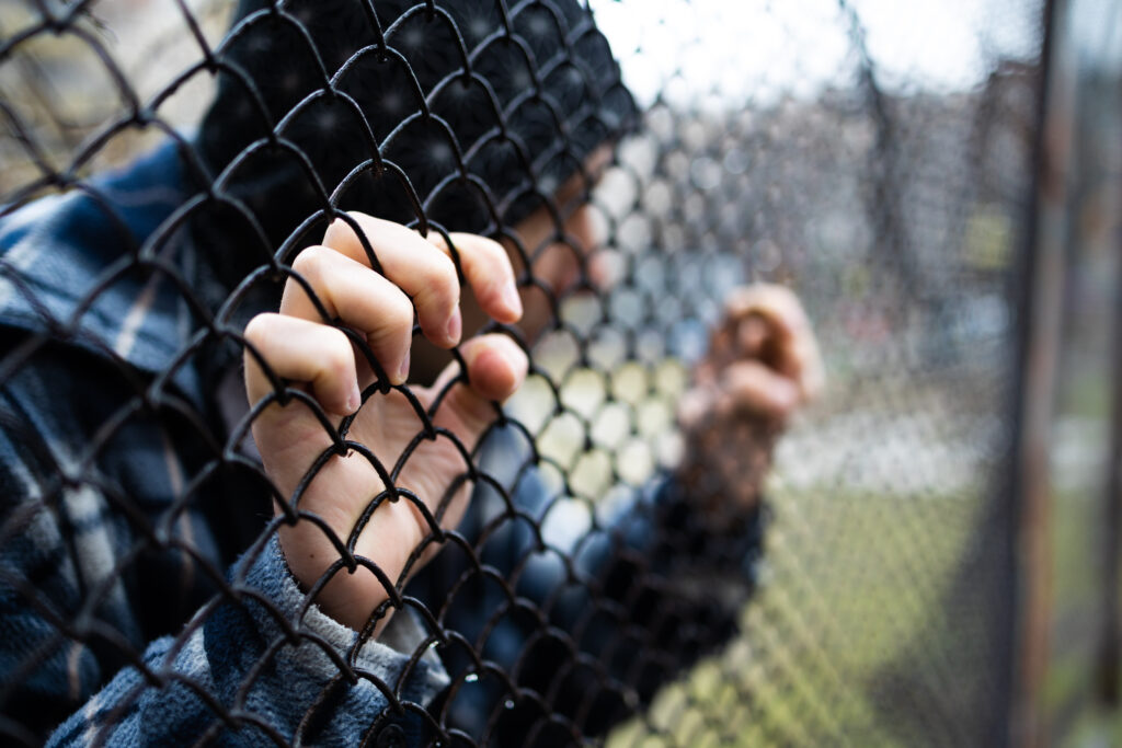 teenager trapped behind a fence