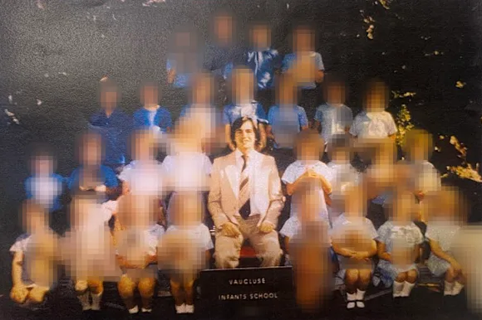 Michael Anthony Lunn with students in a school photo